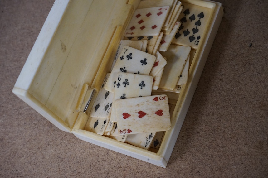 A scrimshaw carved bone miniature playing card set, 10.5cm wide. Condition - fair/good